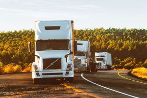 A line of commercial trucks pulled to the side of the road following an albuquerque delivery truck accident