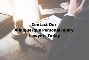 personal injury attorney sitting at desk with paperwork and laptop