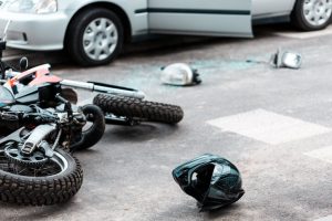 motorcycle accident with helmet and shattered glass on the ground